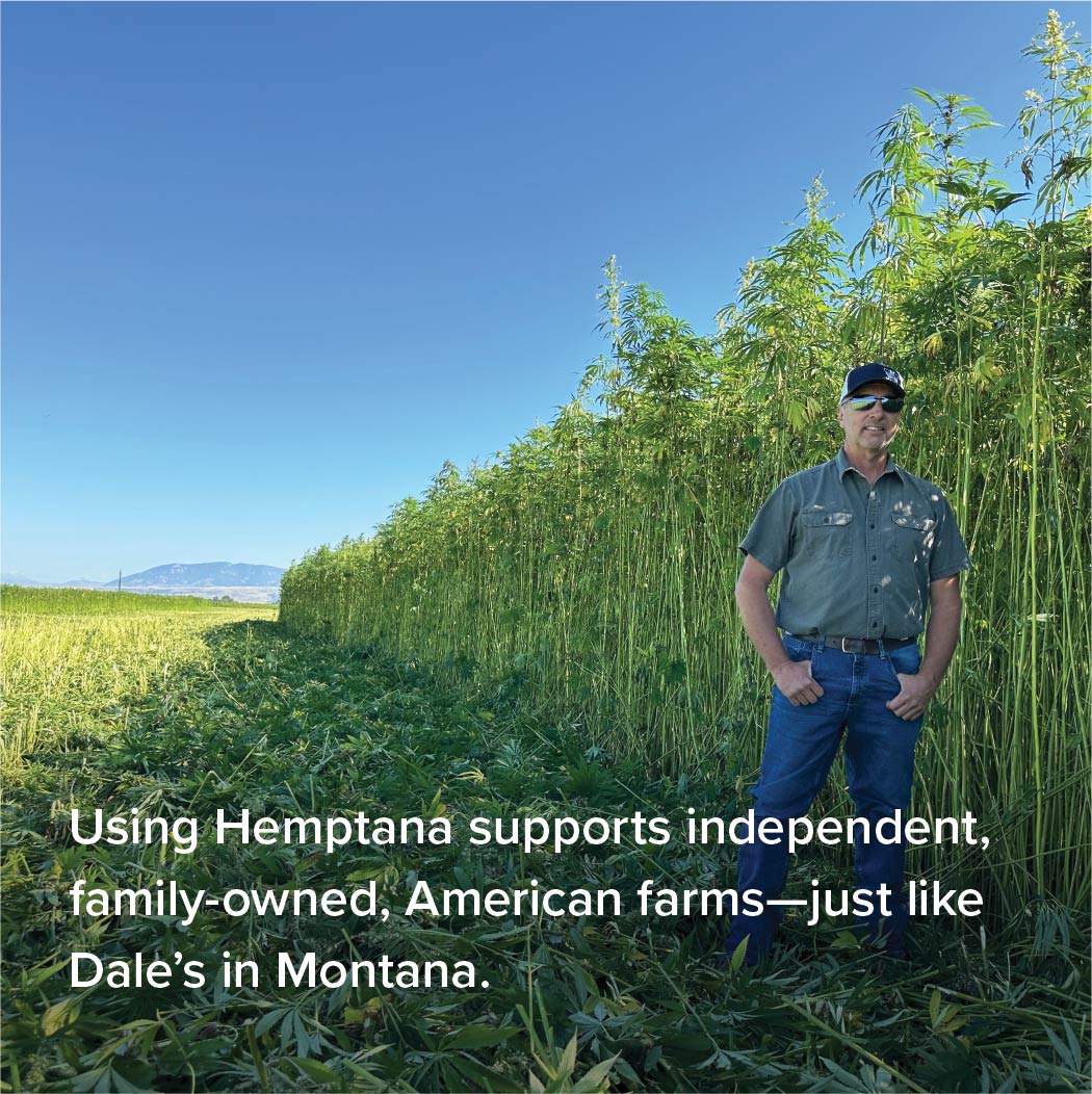 A man standing next to a Hemp crop posing for a picture.